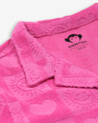 Close-up of Appaman's playful pink resort terry shirt featuring heart patterns, perfect kids clothes for sunny days!
