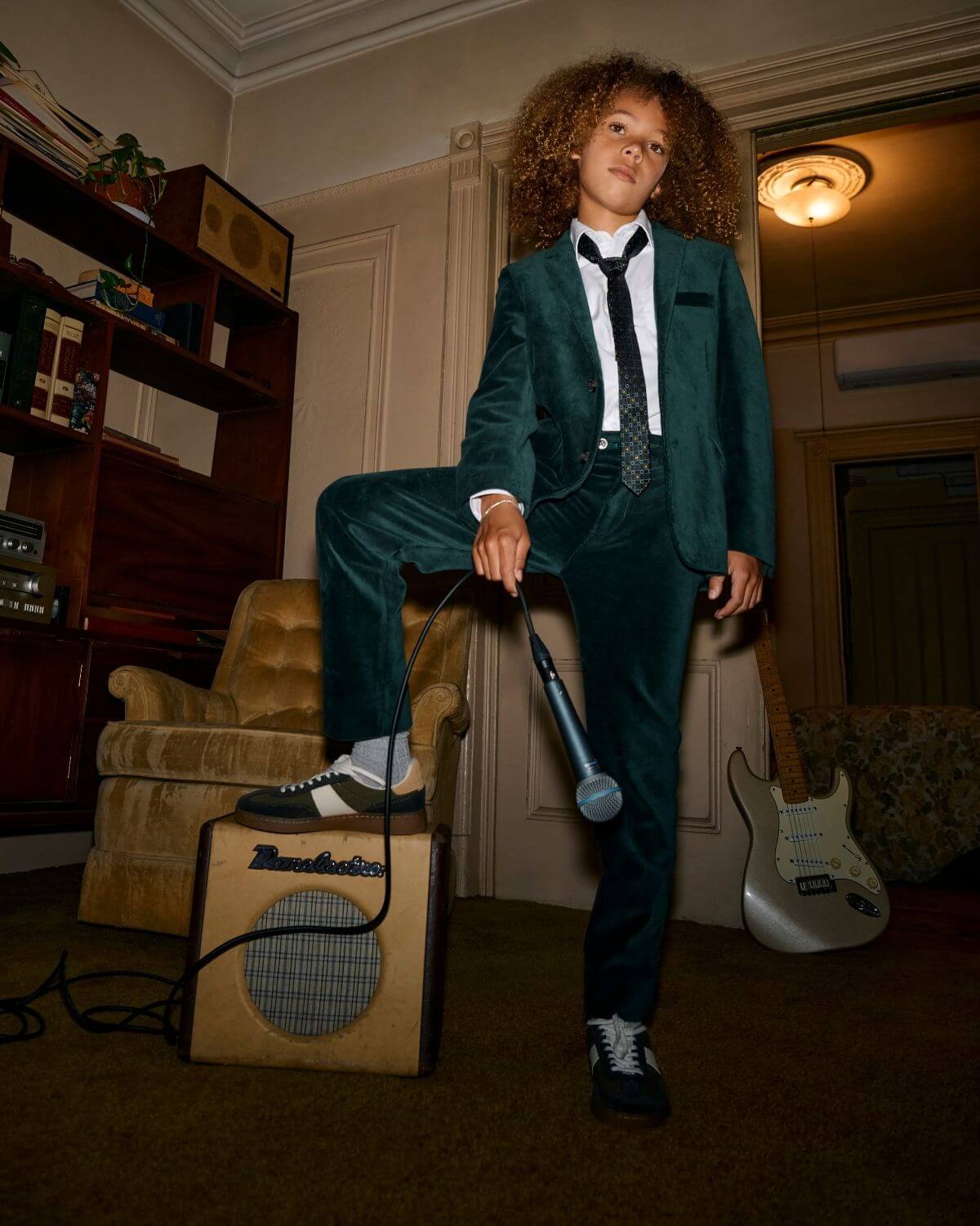 Child wearing Evergreen Velvet Suit Pants with a microphone, styled for a stylish performance.