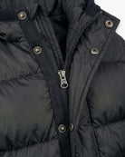 Close-up of the zipper and buttons on a Black Puffy Coat, showcasing its stylish and warm design.