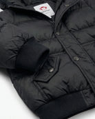 Kids Black Puffy Coat featuring a durable black puffer jacket design with a plush lining and pocket details.