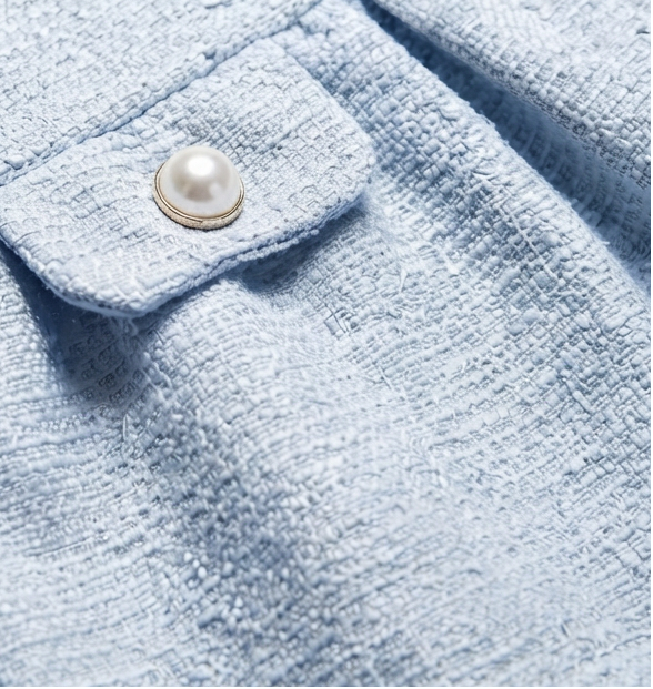 Close-up detail of a girls light blue drop-waist holiday dress