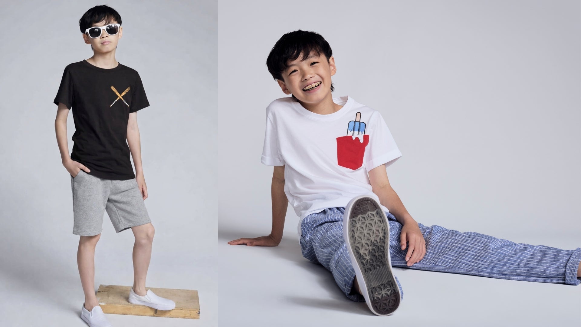 Two children wearing different t-shirts on a plain background