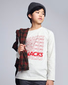 Child wearing a white sweatshirt with 'SNACKS' text, holding a plaid scarf on a gray background