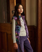 A girl wearing a lavender puffer vest. Appaman Fall/Winter 2026 collection.
