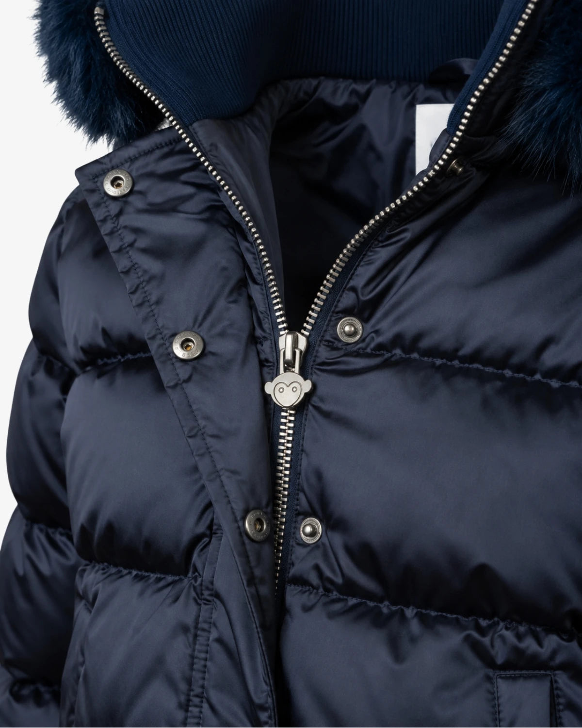 Appaman girls' navy puffer bomber jacket, close-up zip and snap detail.