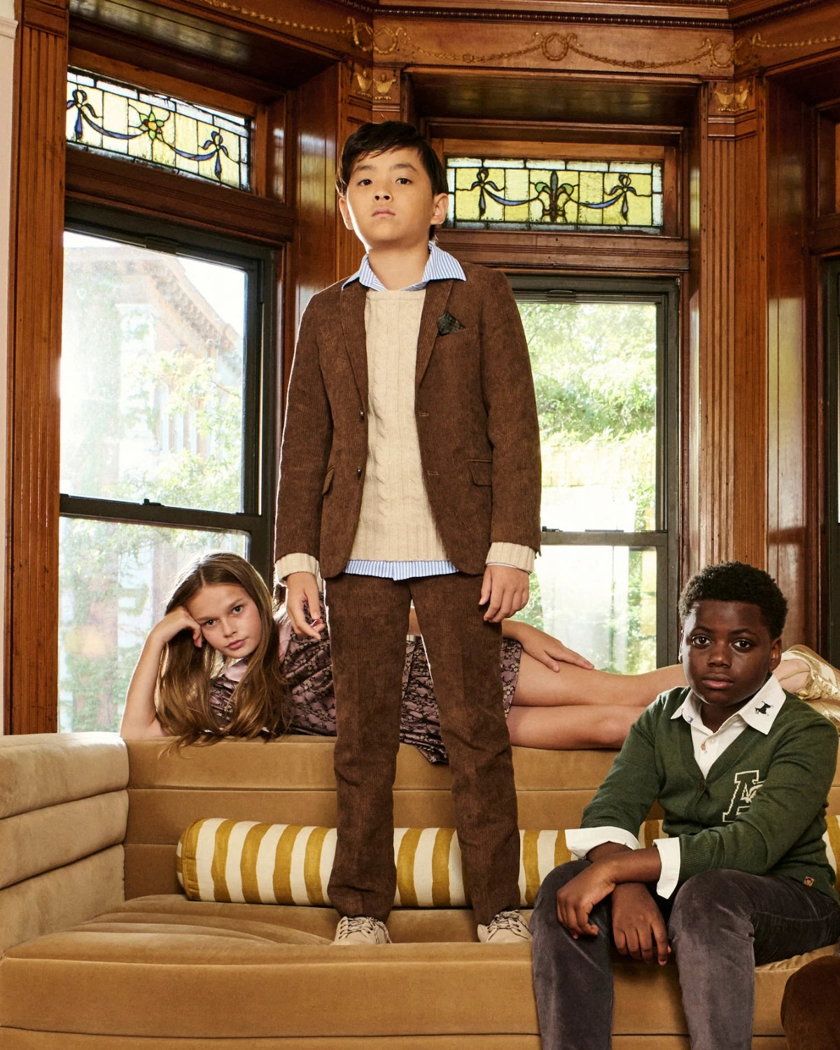 A group lifestyle photo of children wearing Appaman Fall/Winter 2026 outfits in a brownstone parlor setting.