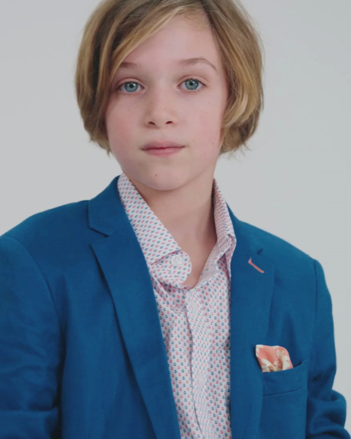 Nautical Blue Stretchy Mod Suit on a young boy showcasing a notch-lapel blazer and contrast pocket square.