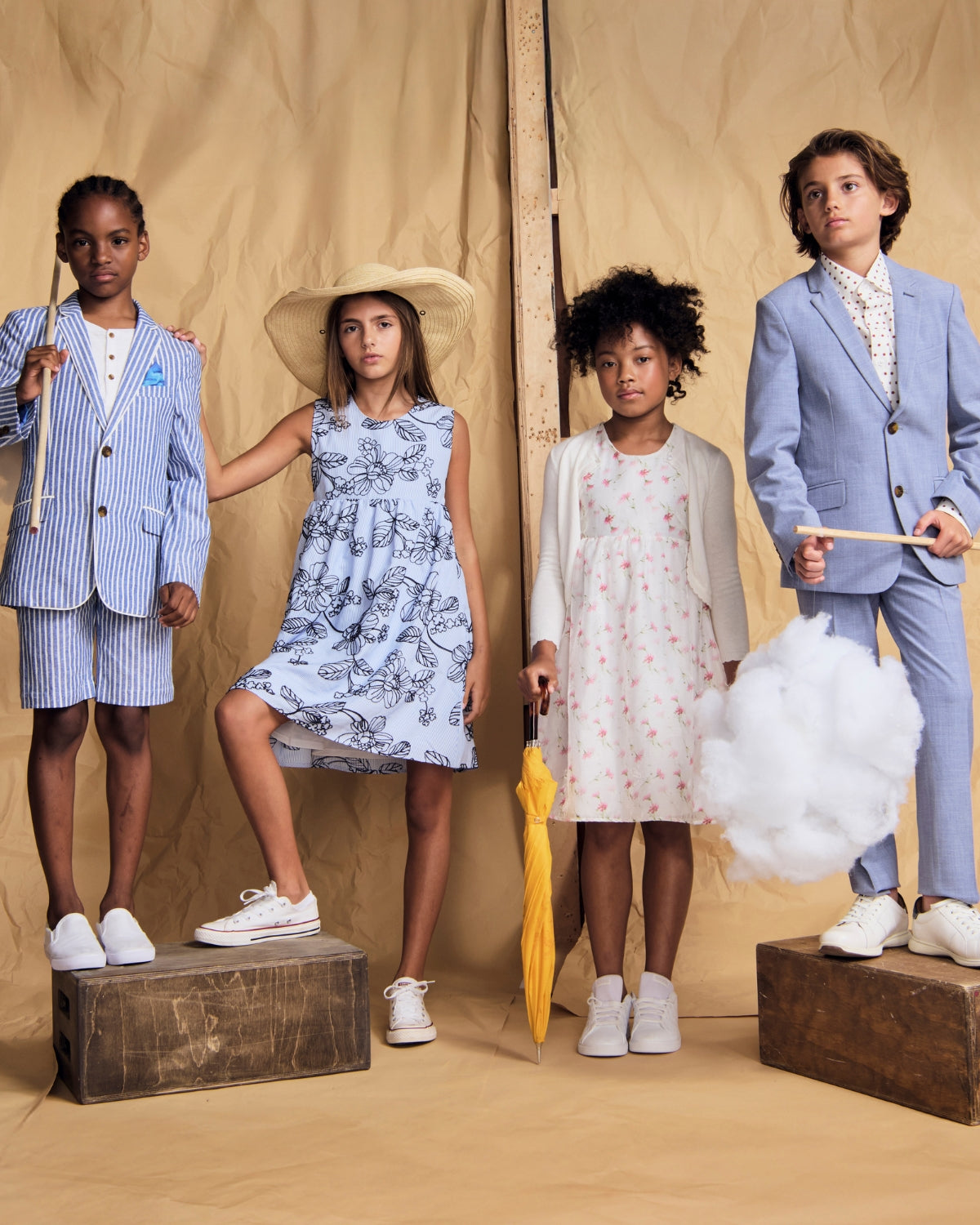 Children wearing high-quality clothing in stylish outfits, showcasing a summer collection with vibrant colors and playful designs.